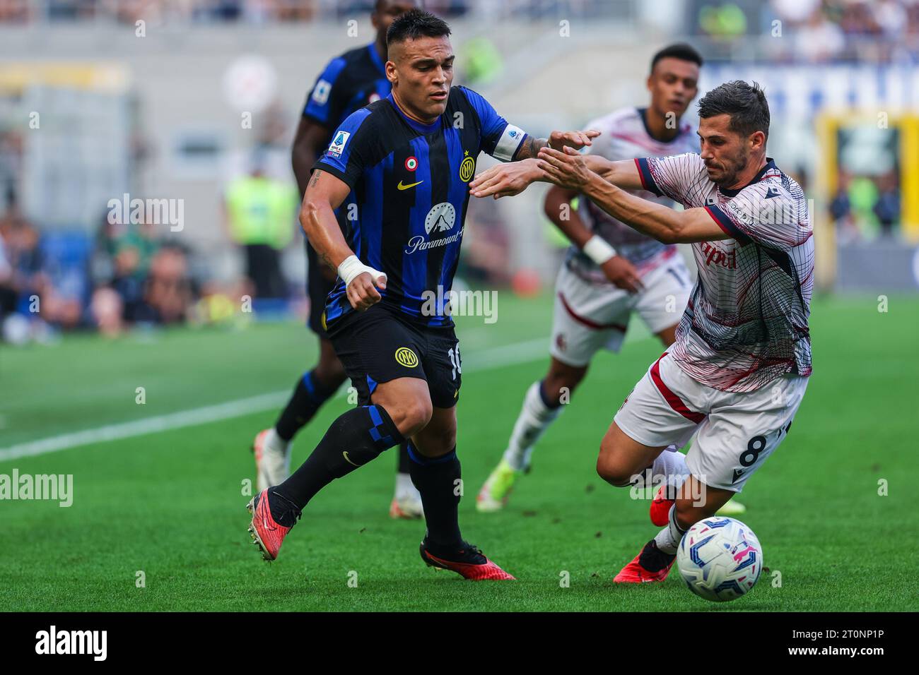 Lautaro Martinez of FC Internazionale (L) and Remo Freuler of Bologna FC (R) in action during the Serie A 2023/24 football match between FC Internazionale and Bologna FC at Giuseppe Meazza Stadium. Final score Inter  2:2  Bologna. Stock Photo