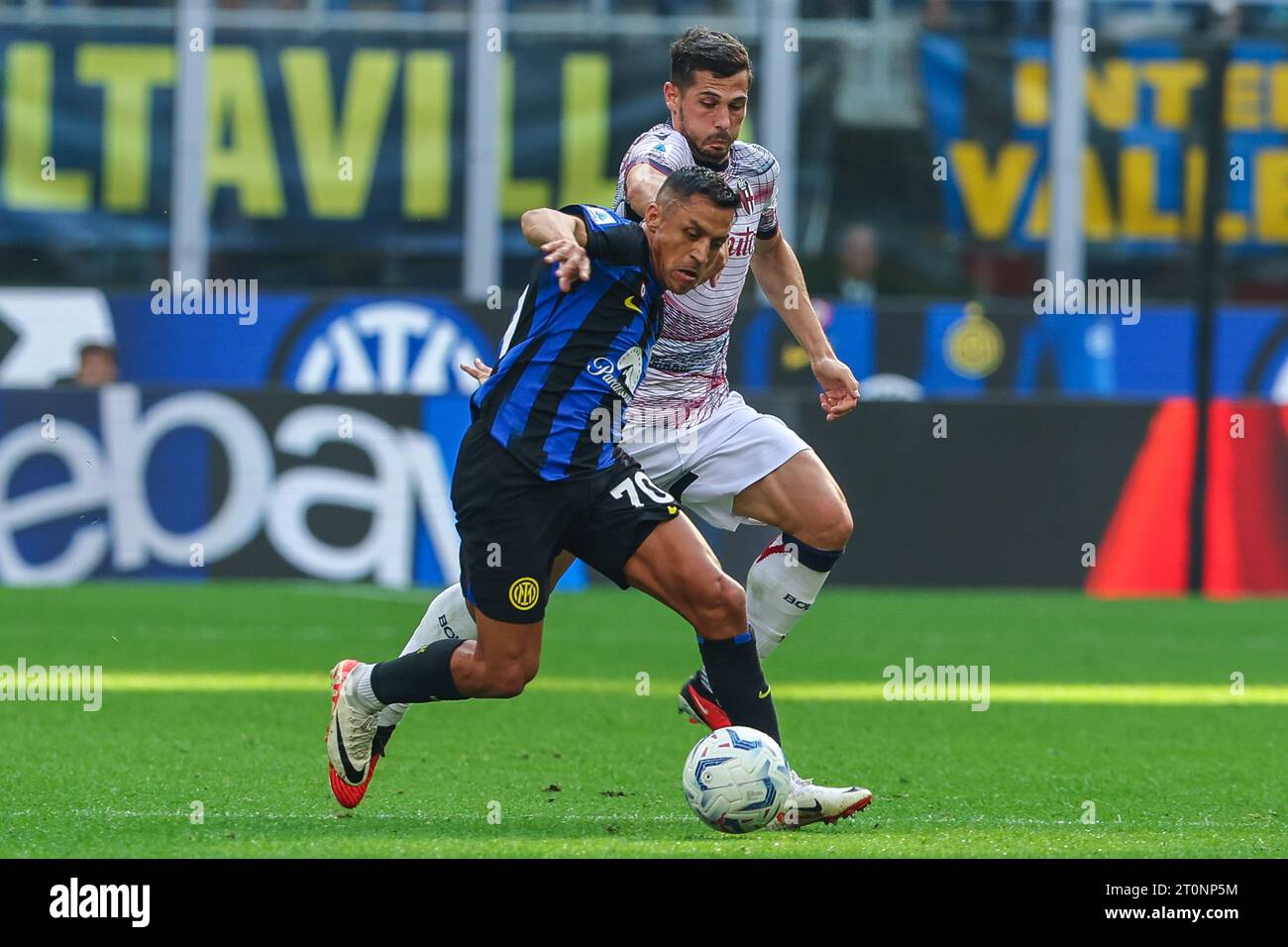 Alexis Sanchez of FC Internazionale (L) and Remo Freuler of Bologna FC (R) in action during the Serie A 2023/24 football match between FC Internazionale and Bologna FC at Giuseppe Meazza Stadium. Final score Inter  2:2  Bologna. Stock Photo