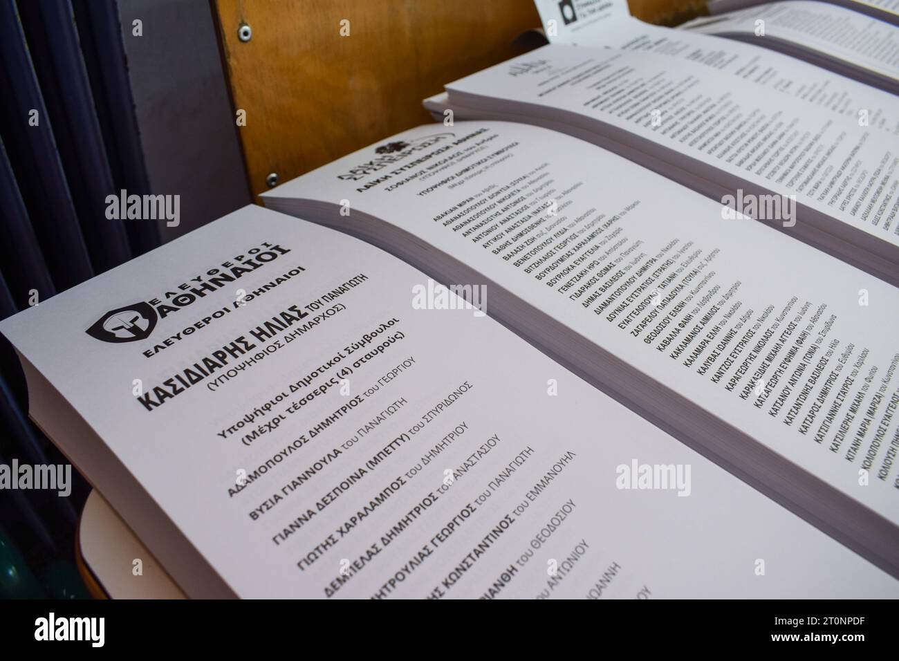 Athens, Greece. 08 October 2023. An ancient Spartan helmet and the name of Ilias Kasidiaris are printed on the ballots (L) for the local elections at a polling station. Despite being jailed, the former far right Golden Dawn deputy leader Ilias Kasidiaris runs for the mayorship of the Greek capital. Citizens vote to elect representatives in 13 regions and hundreds of municipalities throughout the country. Credit: Dimitris Aspiotis/Alamy Live News Stock Photo