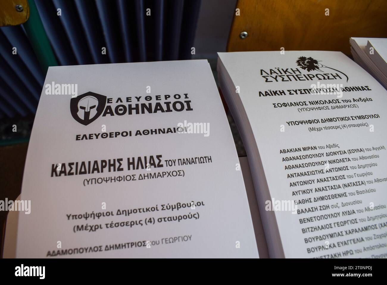 Athens, Greece. 08 October 2023. An ancient Spartan helmet and the name of Ilias Kasidiaris are printed on the ballots (L) for the local elections at a polling station. Despite being jailed, the former far right Golden Dawn deputy leader Ilias Kasidiaris runs for the mayorship of the Greek capital. Citizens vote to elect representatives in 13 regions and hundreds of municipalities throughout the country. Credit: Dimitris Aspiotis/Alamy Live News Stock Photo