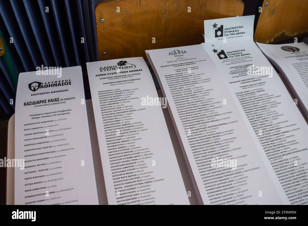 Athens, Greece. 08 October 2023. An ancient Spartan helmet and the name of Ilias Kasidiaris are printed on the ballots (L) for the local elections at a polling station. Despite being jailed, the former far right Golden Dawn deputy leader Ilias Kasidiaris runs for the mayorship of the Greek capital. Citizens vote to elect representatives in 13 regions and hundreds of municipalities throughout the country. Credit: Dimitris Aspiotis/Alamy Live News Stock Photo
