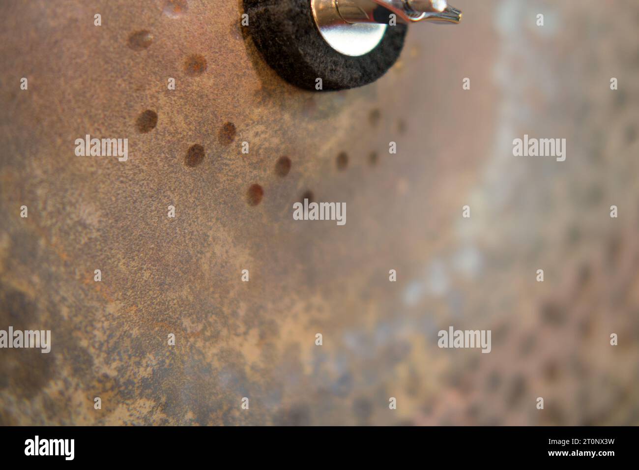 Close-up of a rusting metal cymbal . Selective focus. Stock Photo