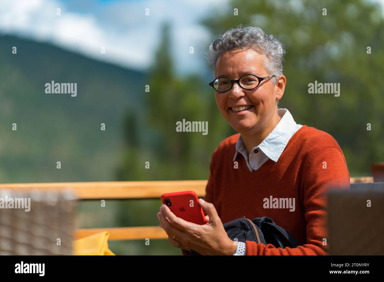 Woman smiling and holding the phone Stock Photo