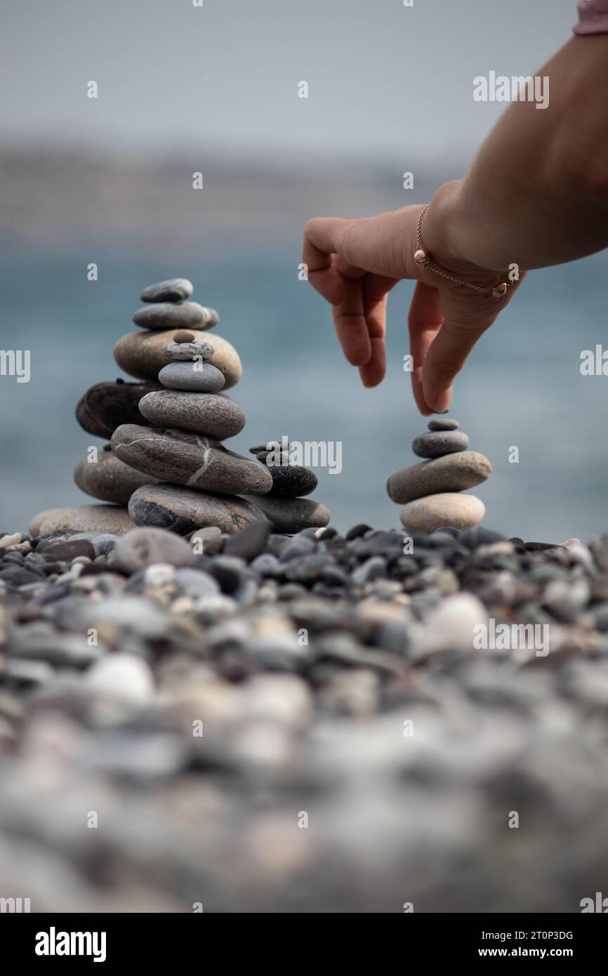 Hand hands stone beach hi-res stock photography and images - Alamy