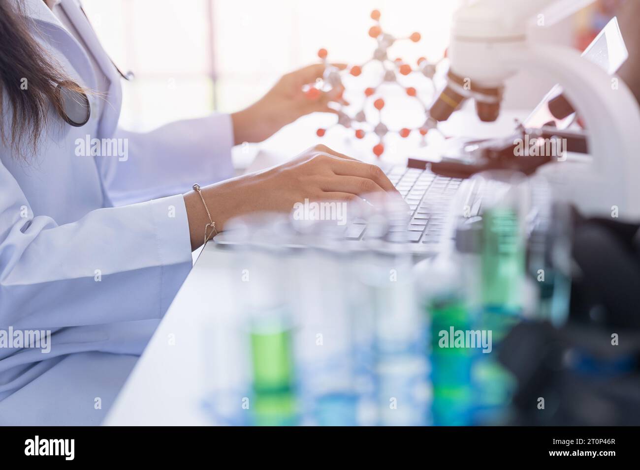 Scientist working in advance science lab using super computer processing record data and calculation science chemical model Stock Photo
