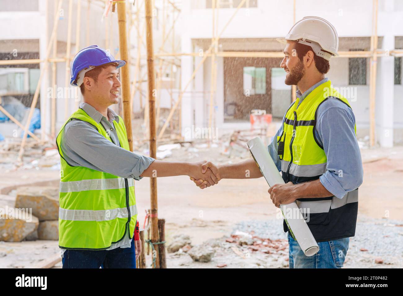 builder worker meeting hand shaking with project manager engineer team leader for success job deal teamwork people Stock Photo