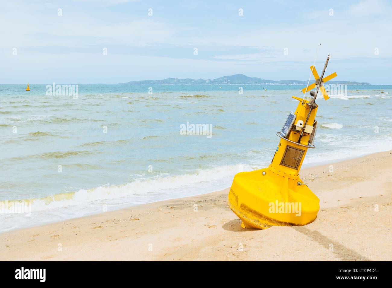 Ocean buoy environment sensor with CCTV camera out of service rest at sand beach waiting for repair maintenance Stock Photo