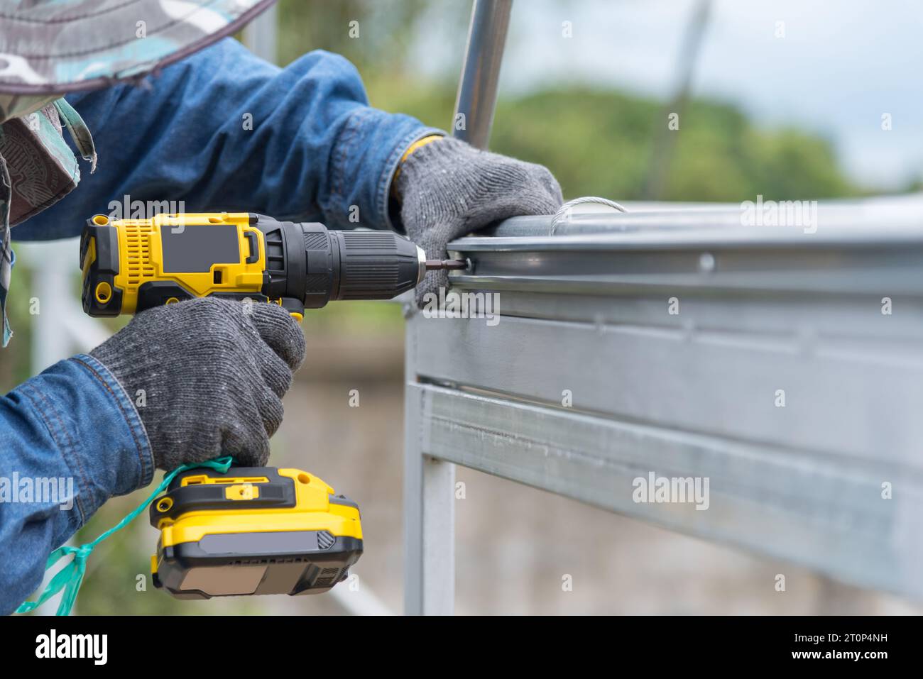 Worker installing screw the Channel Wire Lock to greenhouse Stock Photo Alamy