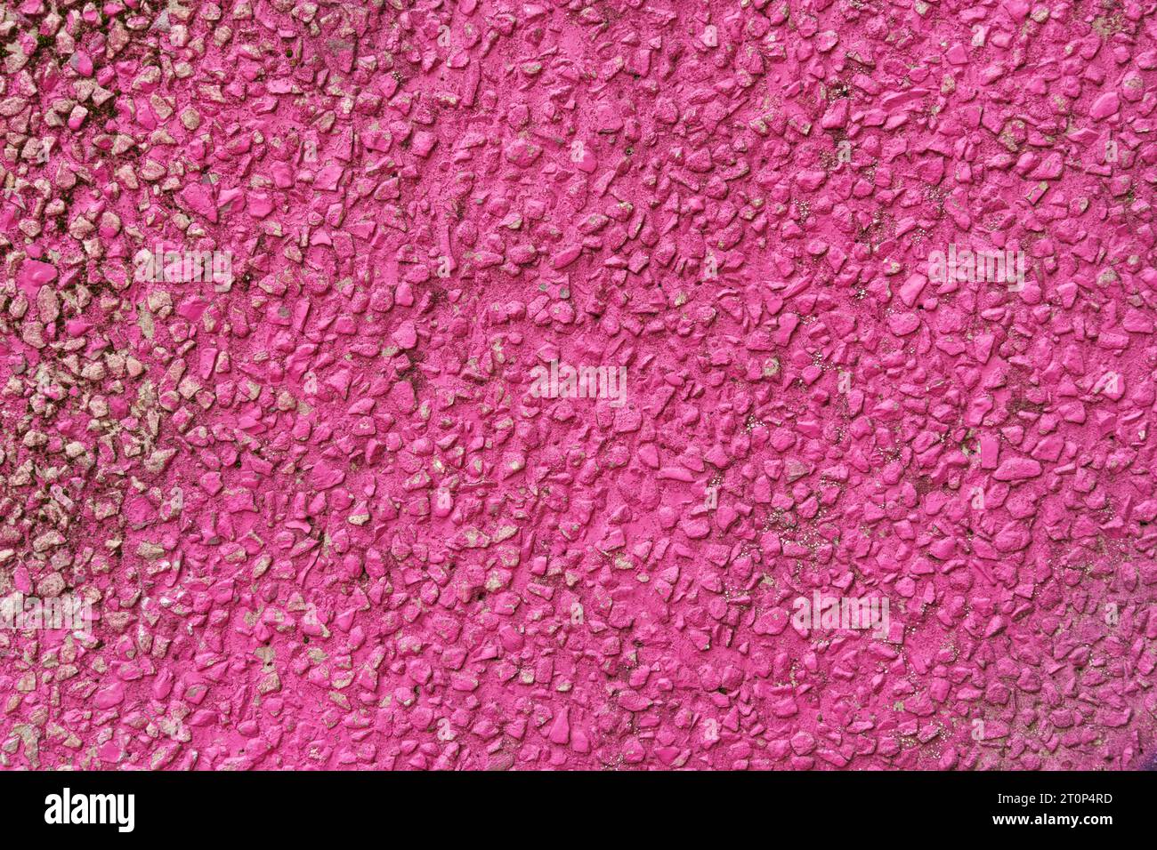 The texture of a wall made of fine gravel painted red. Backgrounds and textures. Stock Photo