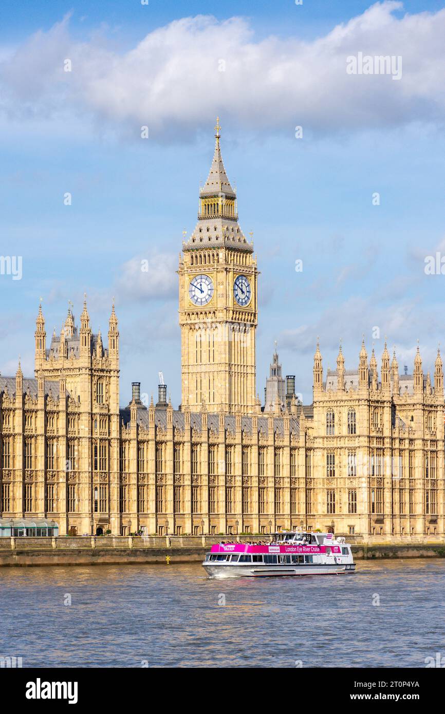 London Eye River Cruise Boat and Houses of Parliament across River Thames, London Borough of Lambeth, Greater London, England, United Kingdom Stock Photo
