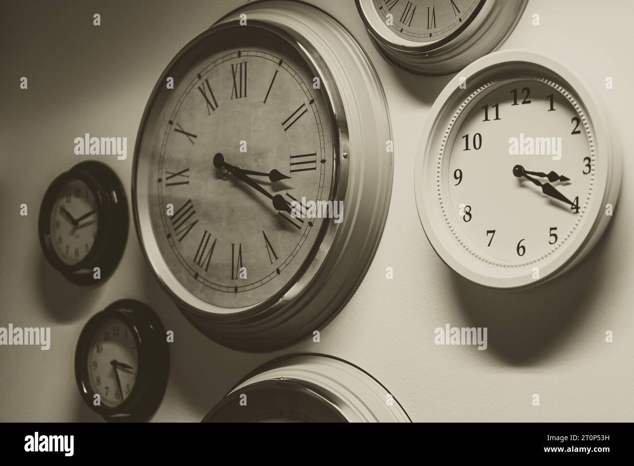 classic old times memory concept. many retro style time clocks hanging on the wall vintage color tone Stock Photo
