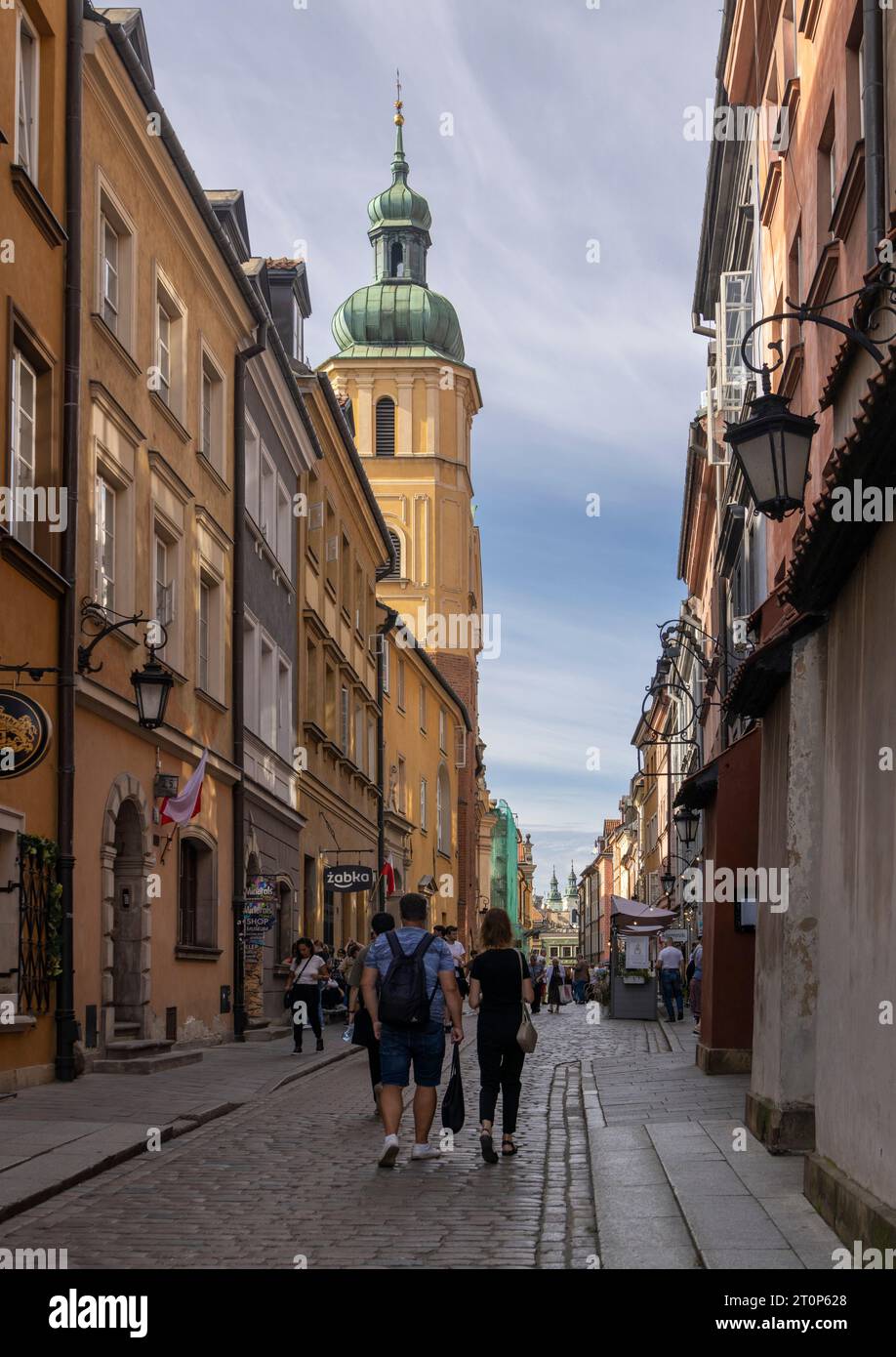 tourists in narrow street in the Old Town, Warsaw, Poland Stock Photo