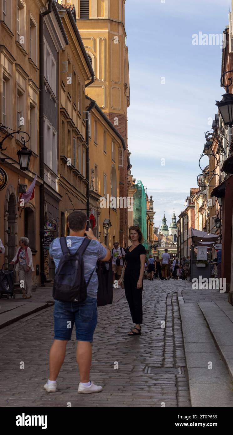 tourists photographing  in narrow street in the Old Town, Warsaw, Poland Stock Photo