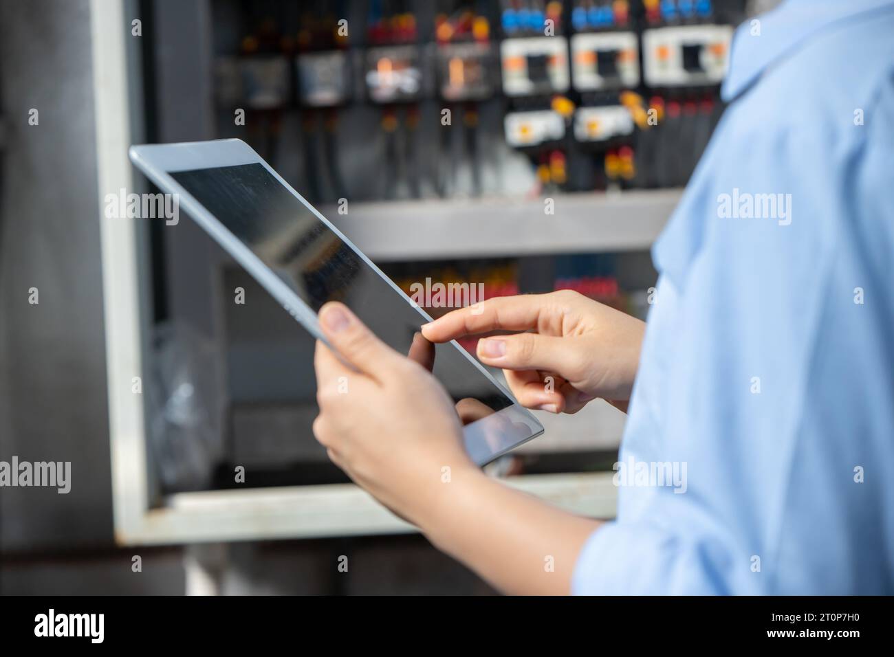 Electrician Engineer using  software check service maintenance electricity main circuit fuse and power system in industry factory Stock Photo
