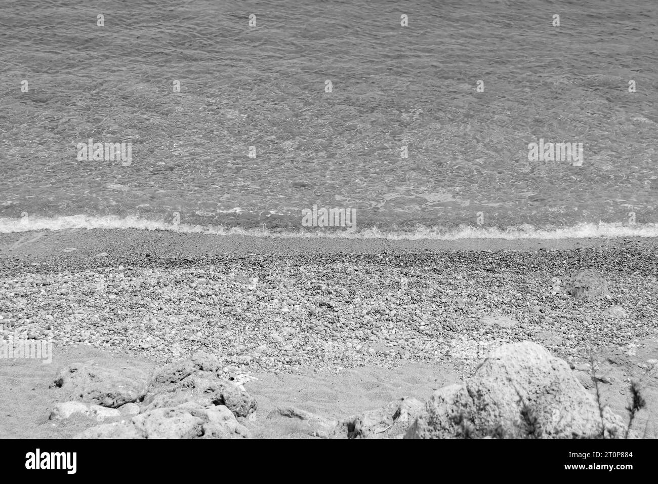 Black and white clear water at Paralia Ixia beach off Rhodes city Stock Photo