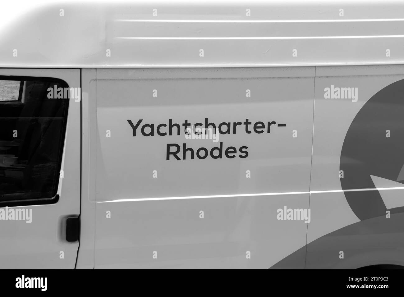 Yachtcharter Rhodes, a company offering rental yacht boats logo designed on a service vehicle for the company in black and white Stock Photo