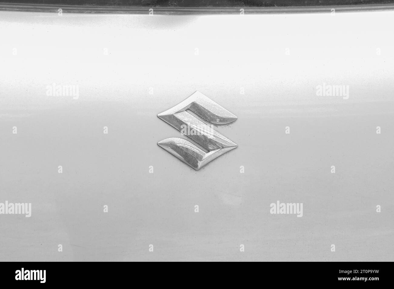 Suzuki metal logo on white car in black and white Stock Photo