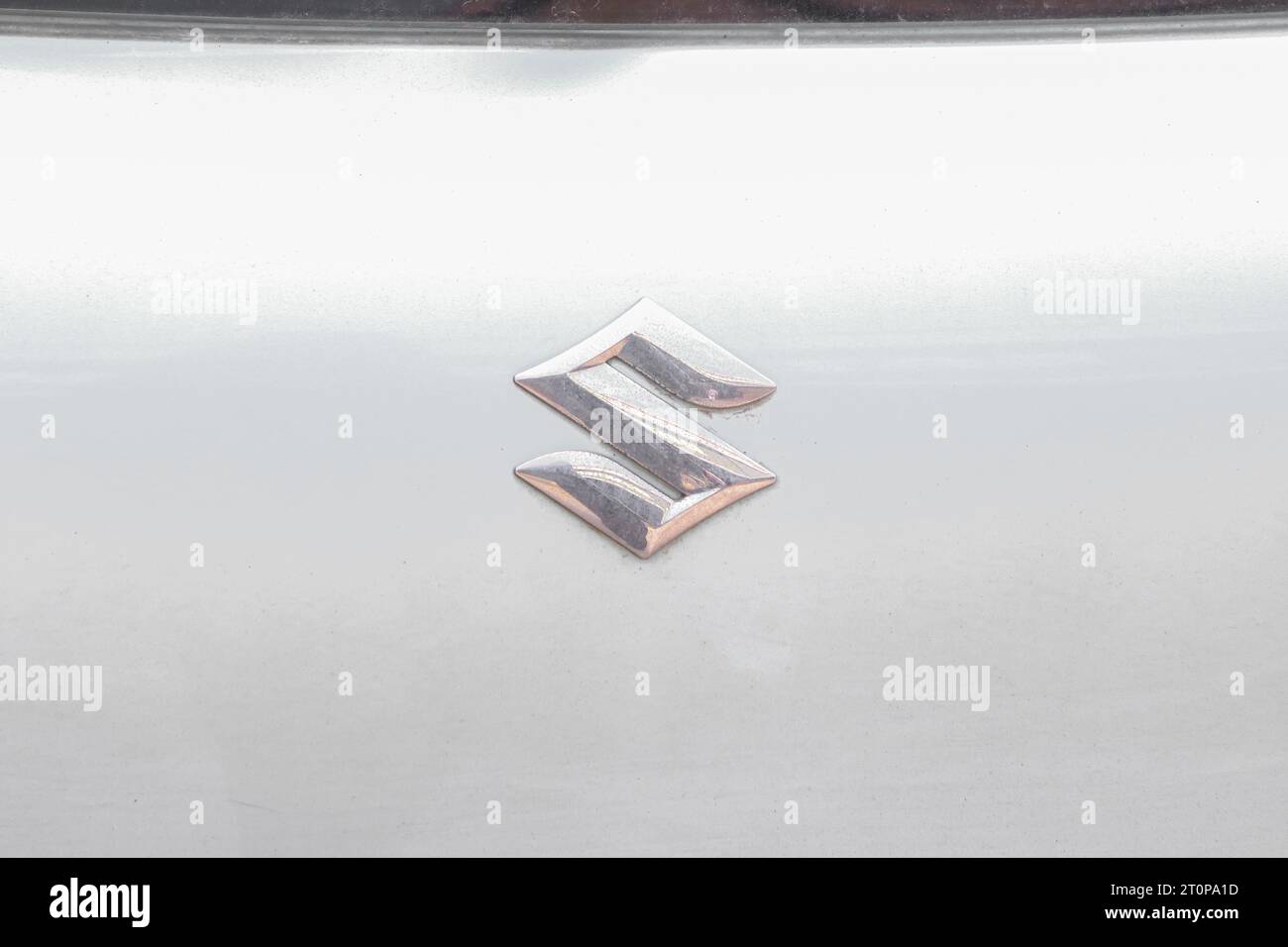 Suzuki metal logo on white car Stock Photo