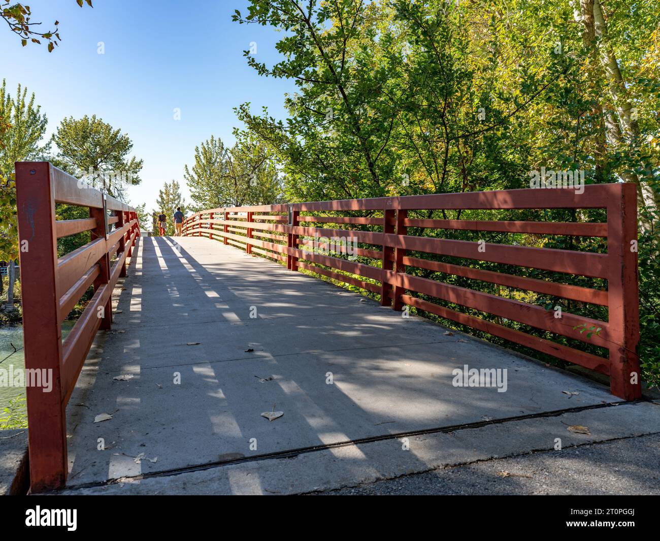 Red railed bridge in a downtown Boise city park Stock Photo
