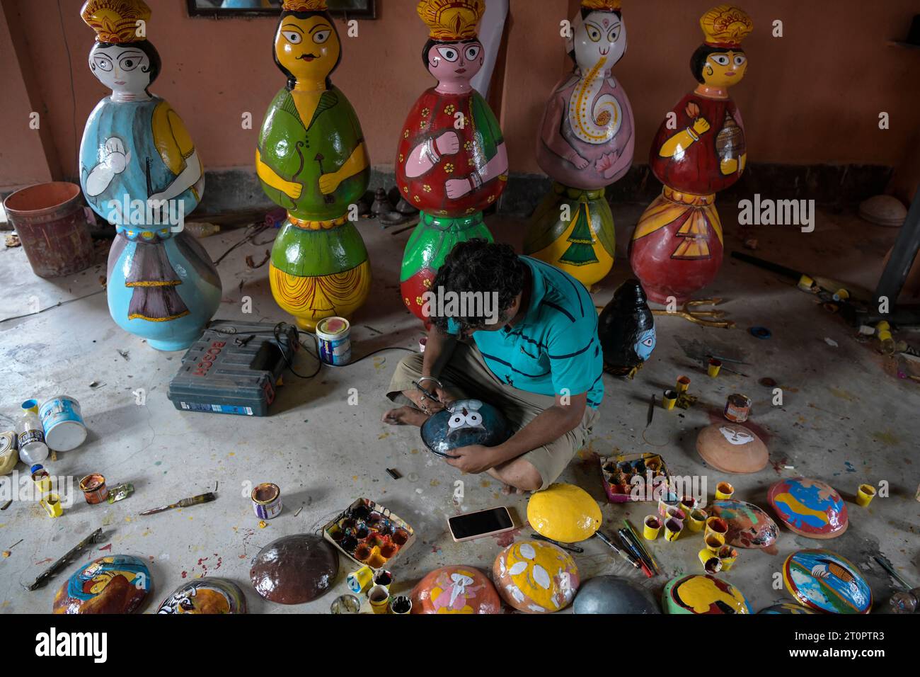 Kolkata, India. 08th Oct, 2023. An artisan is seen preparing idols of