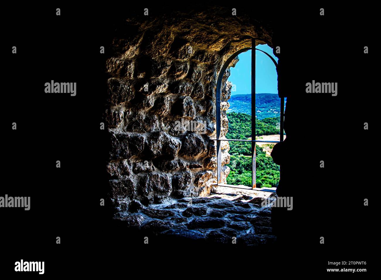 Old metal window frame in a thick wall Stock Photo