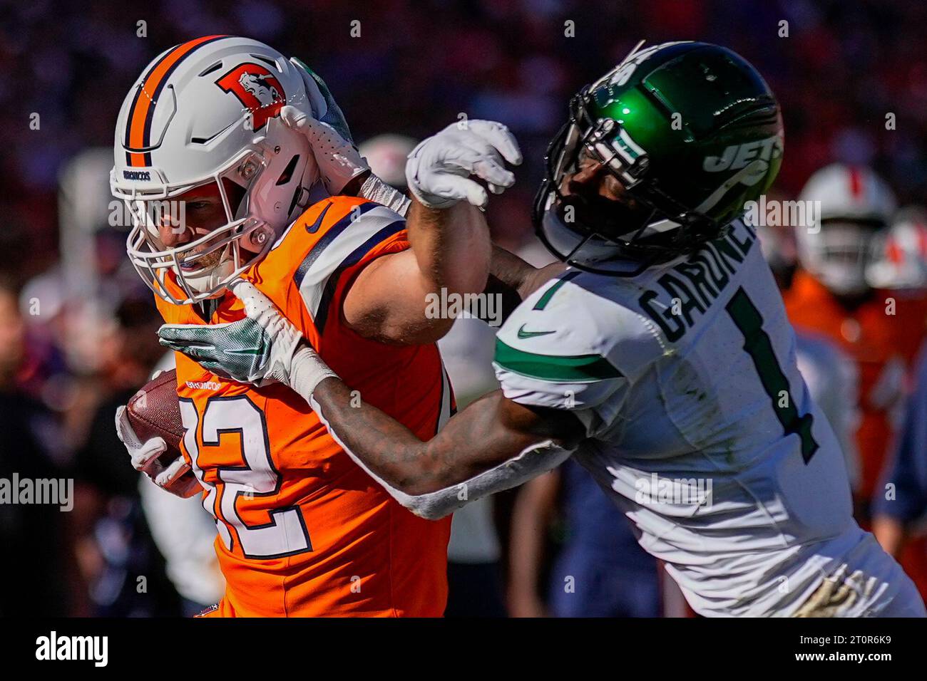 Denver Broncos tight end Adam Trautman is pushed out of bounds by New ...