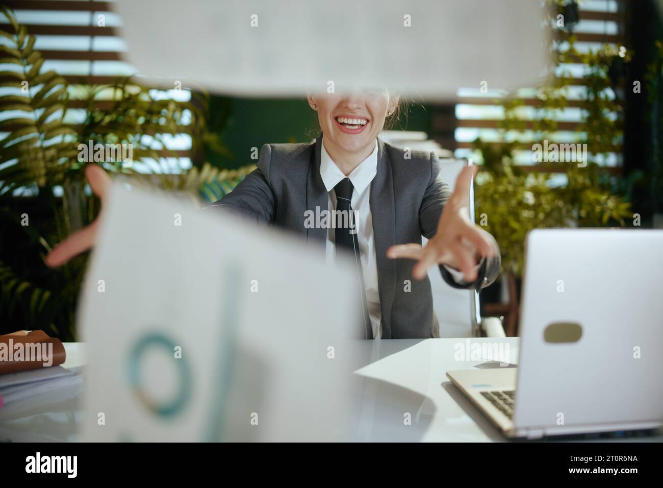 New job. modern female employee in modern green office in grey business ...