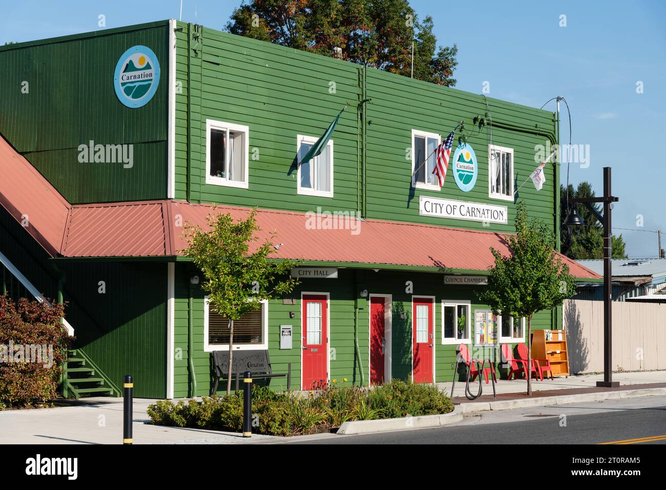 Carnation, WA, USA - October 8, 2023; City of Carnation green wooden office building with red wrap around awning Stock Photo