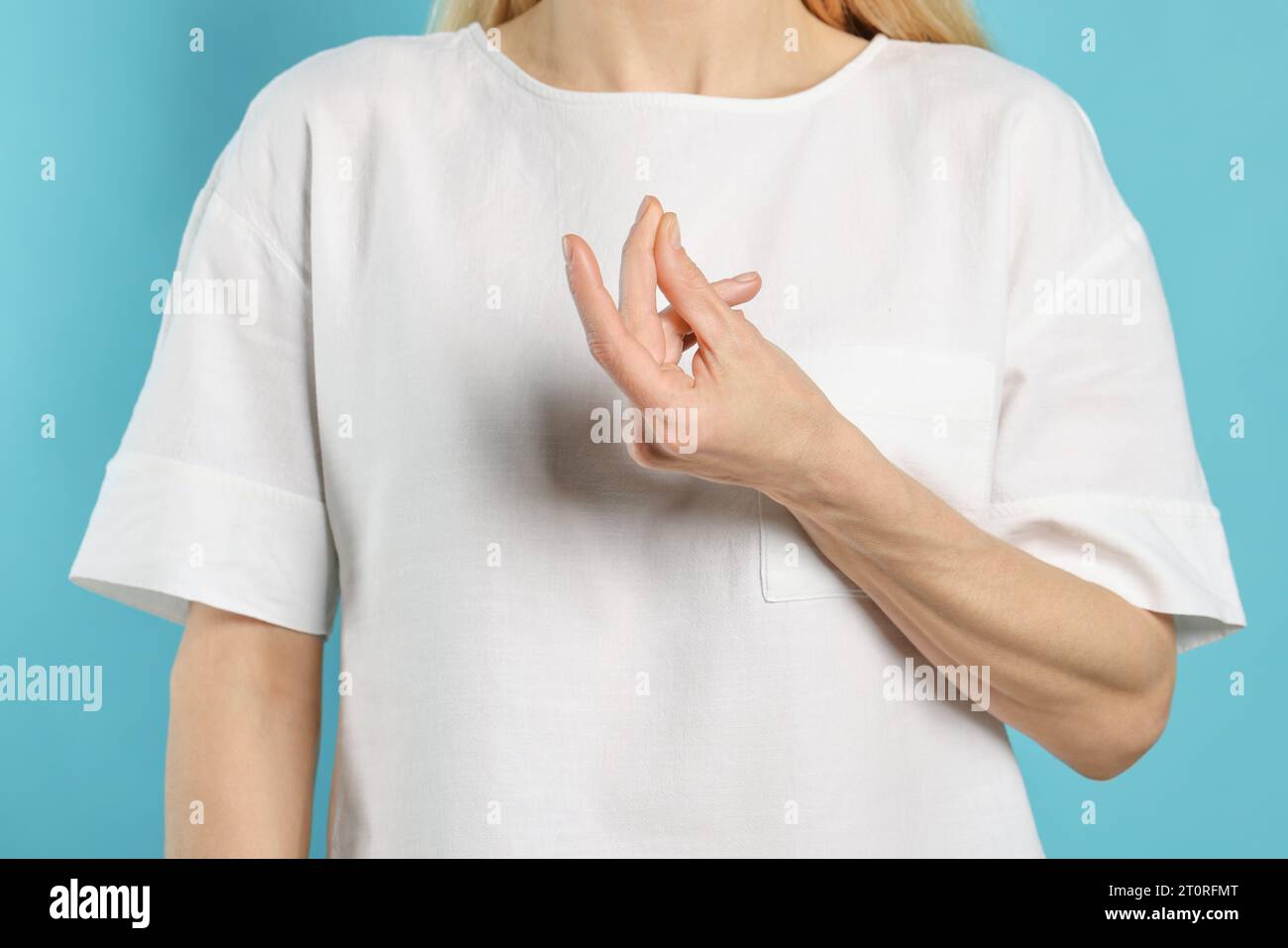 Woman snapping her fingers on turquoise background, closeup. Bad habit Stock Photo Alamy