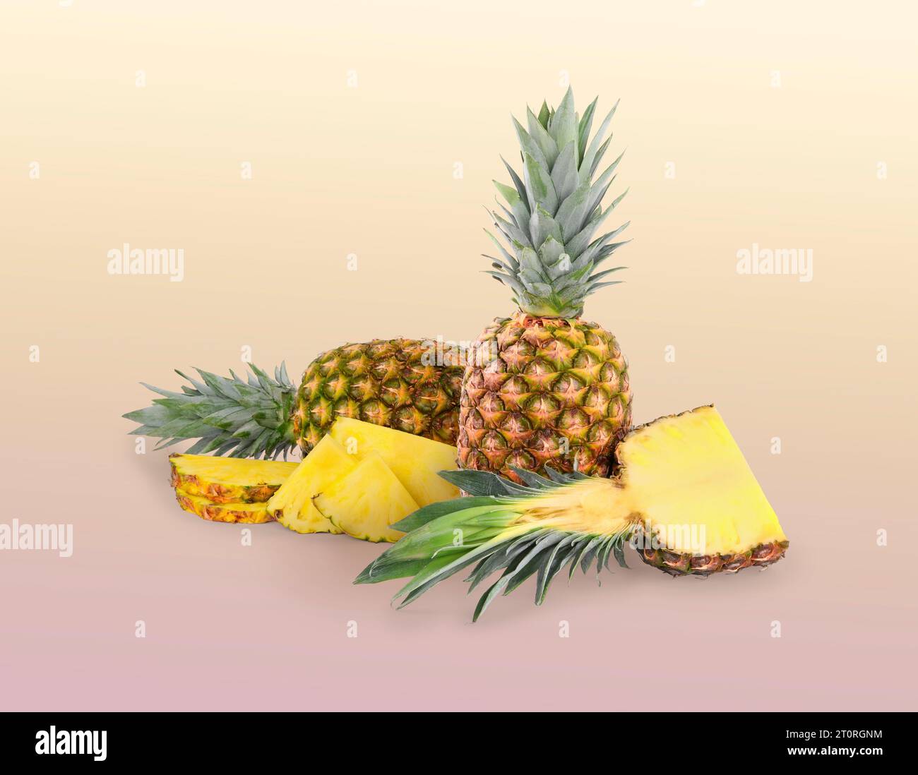 Cut and whole pineapples on color gradient background Stock Photo - Alamy