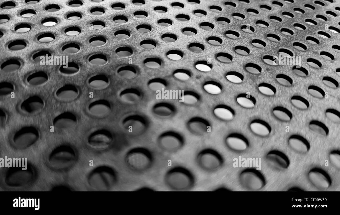 black sheet metal texture with dotted holes Stock Photo