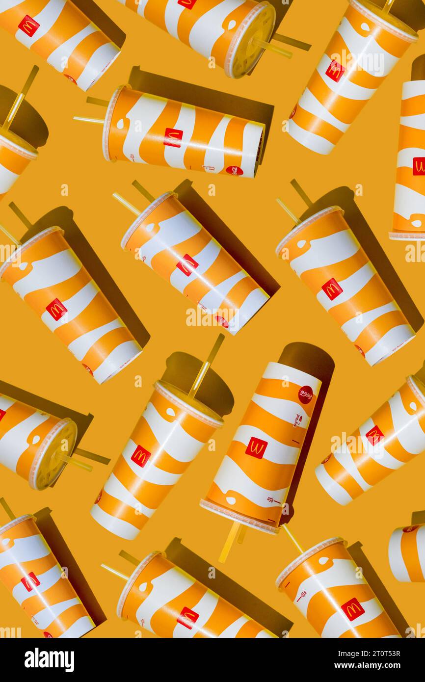 Yellow glass of McDonald's. Paper cup with lid. Takeaway drink ...