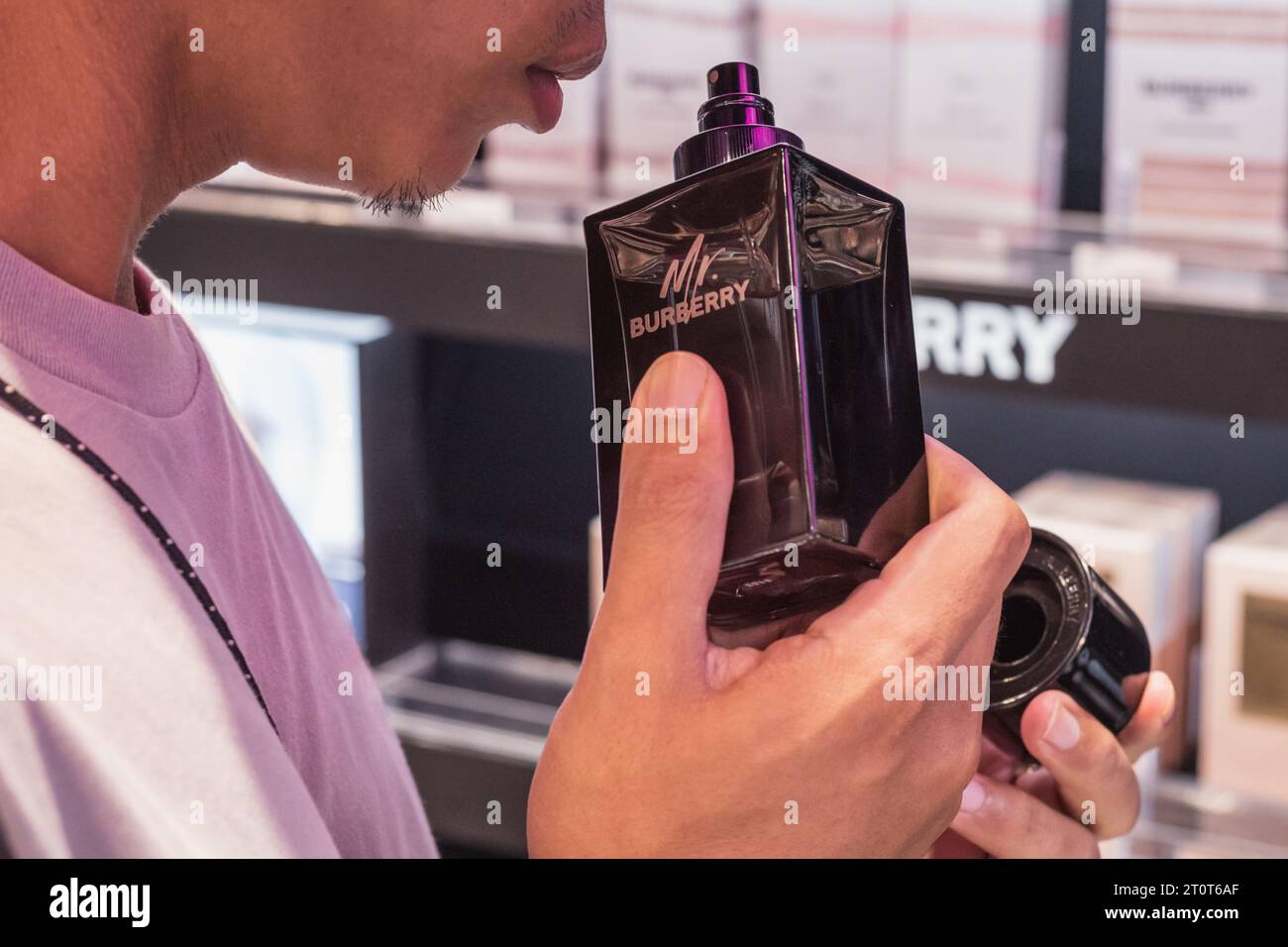 Bangkok, Thailand - September 16, 2023: an unrecognizable Asian man smells Mr. Burberry perfume in a fragrance shop. Stock Photo