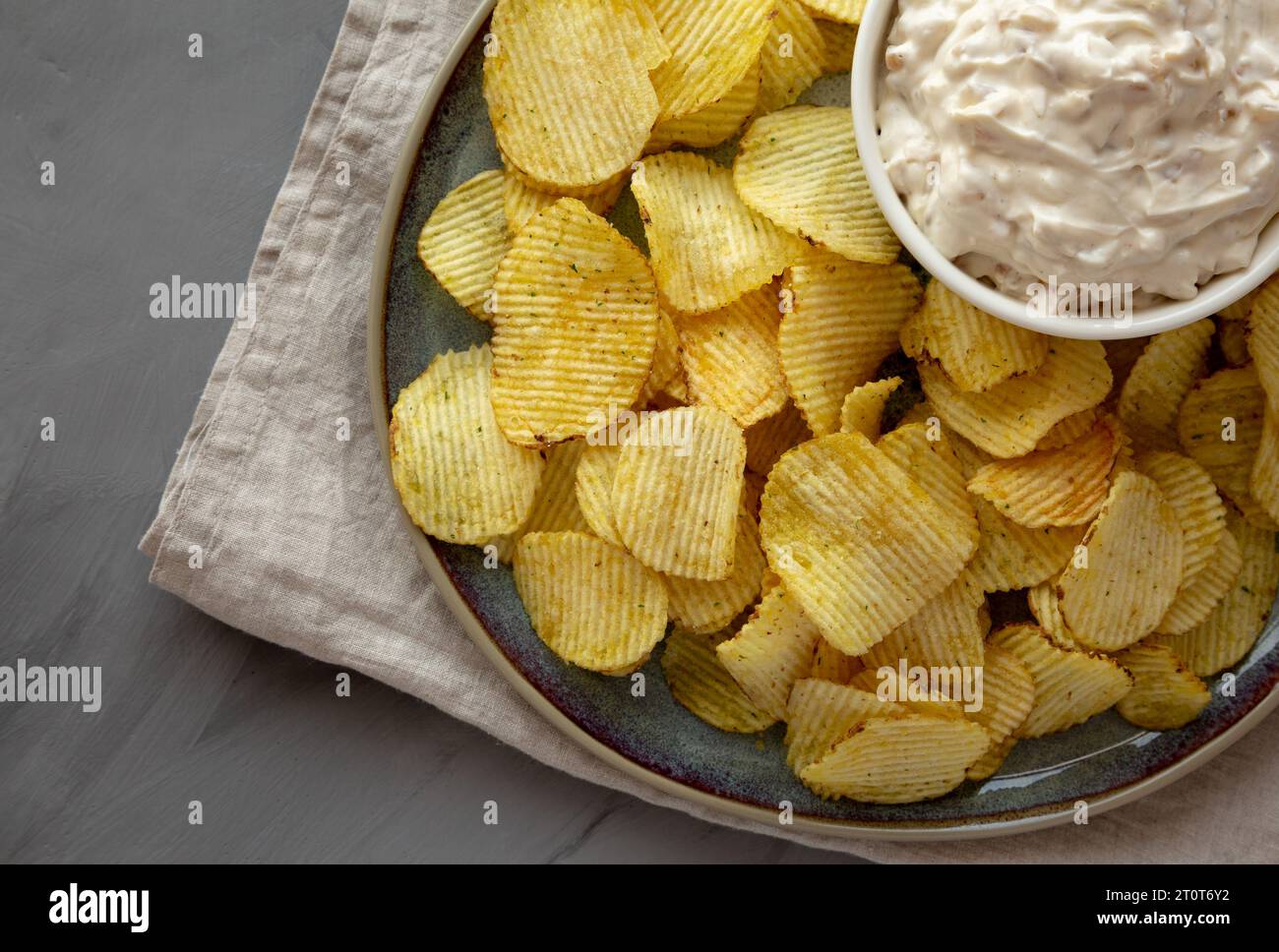 Crispy Crinkle Potato Chips and French Onion Dip on a Plate, top view