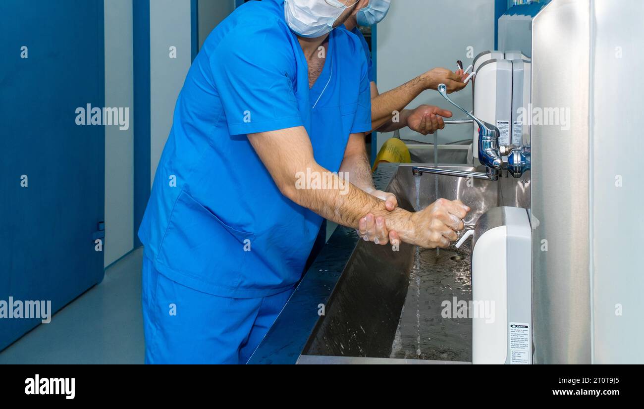 A team of surgeons wash their hands before surgery. Selective focus
