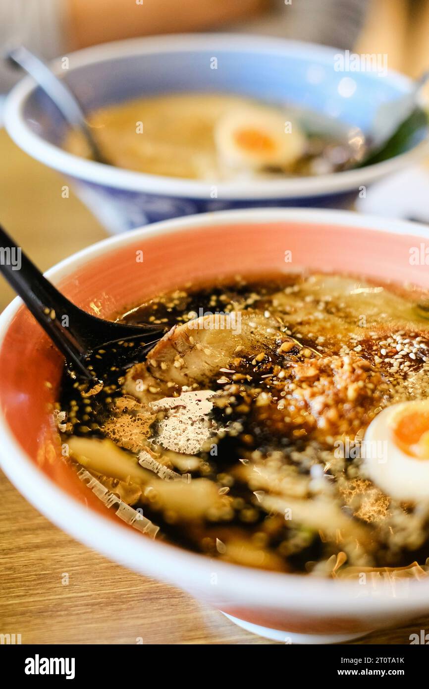 Two bowls of tonkotsu ramen (shoyu base and black garlic oil) with soft