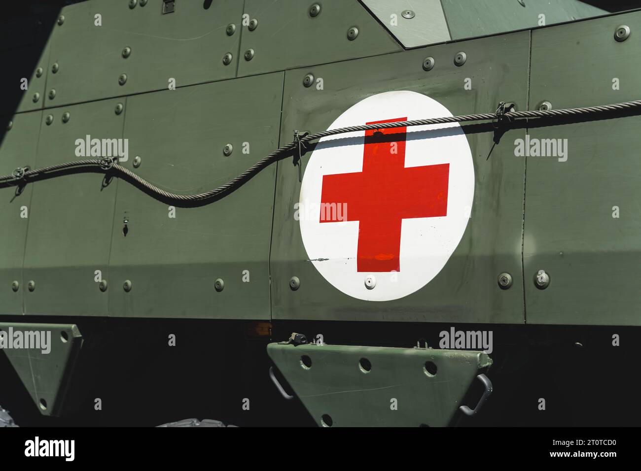 Red cross in a white circle printed on the back of a military transport machine. Doctor and medical staff in the military. High quality photo Stock Photo