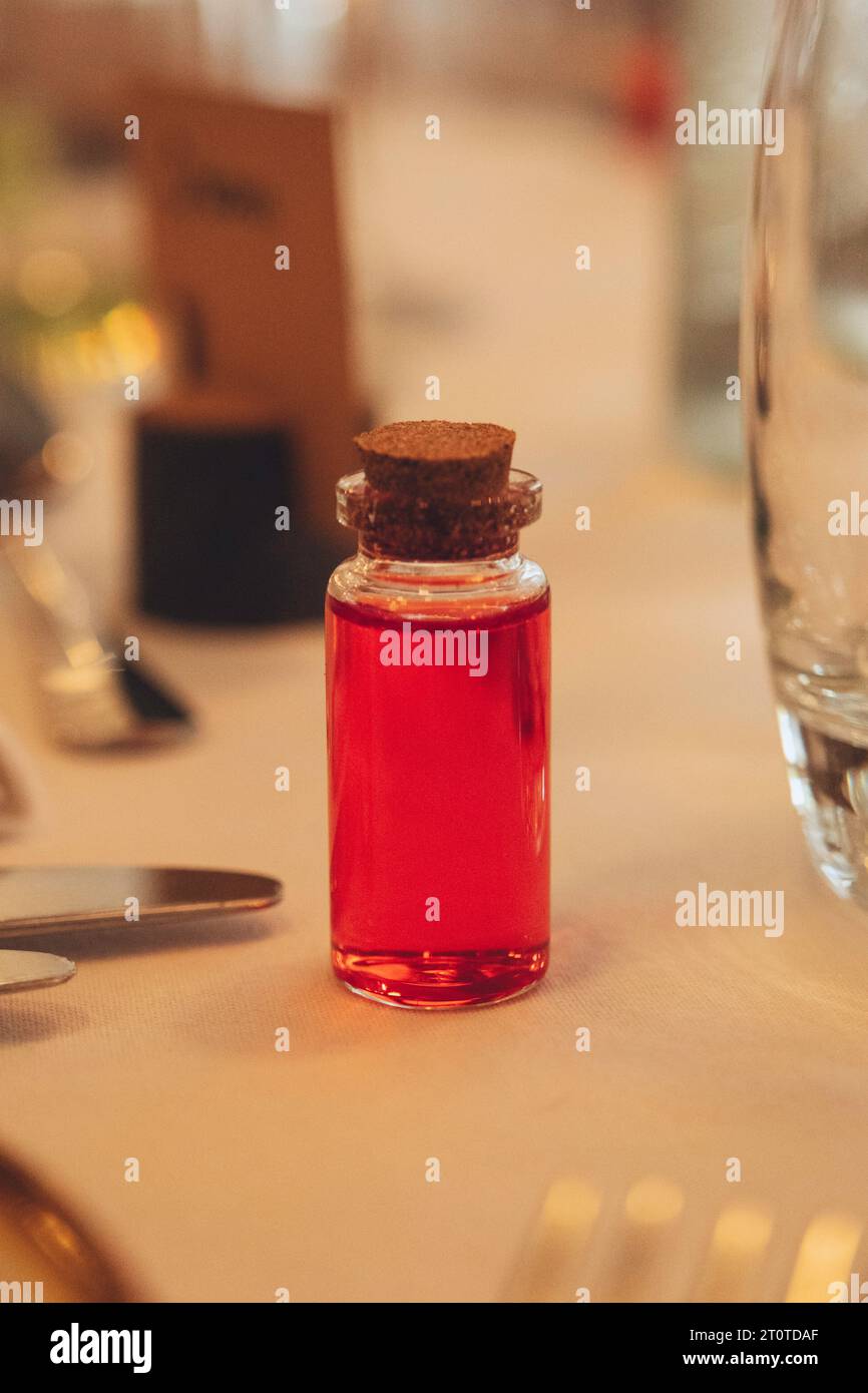Wedding table decorations - A shot in a small medicine jar Stock Photo