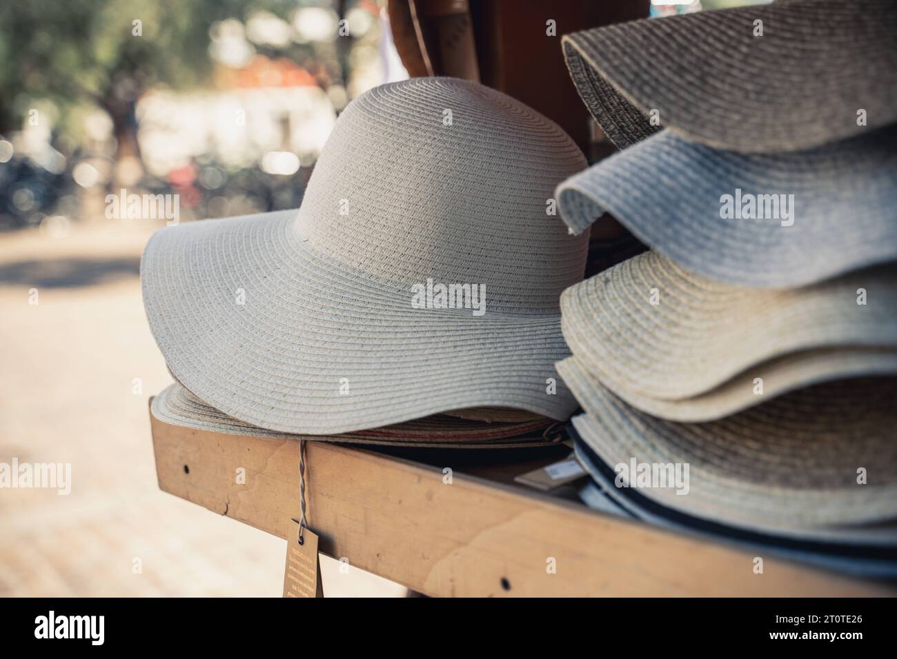 Italy - 7 August 2023: Sun hats in a wooden shelf for sale *** Sonnenhüte in einem Holz Regal zum Verkauf Stock Photo