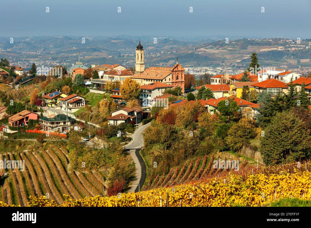 View of the small town of Treiso among colorful autumnal trees and vineyards in Piedmont, Italy. Stock Photo