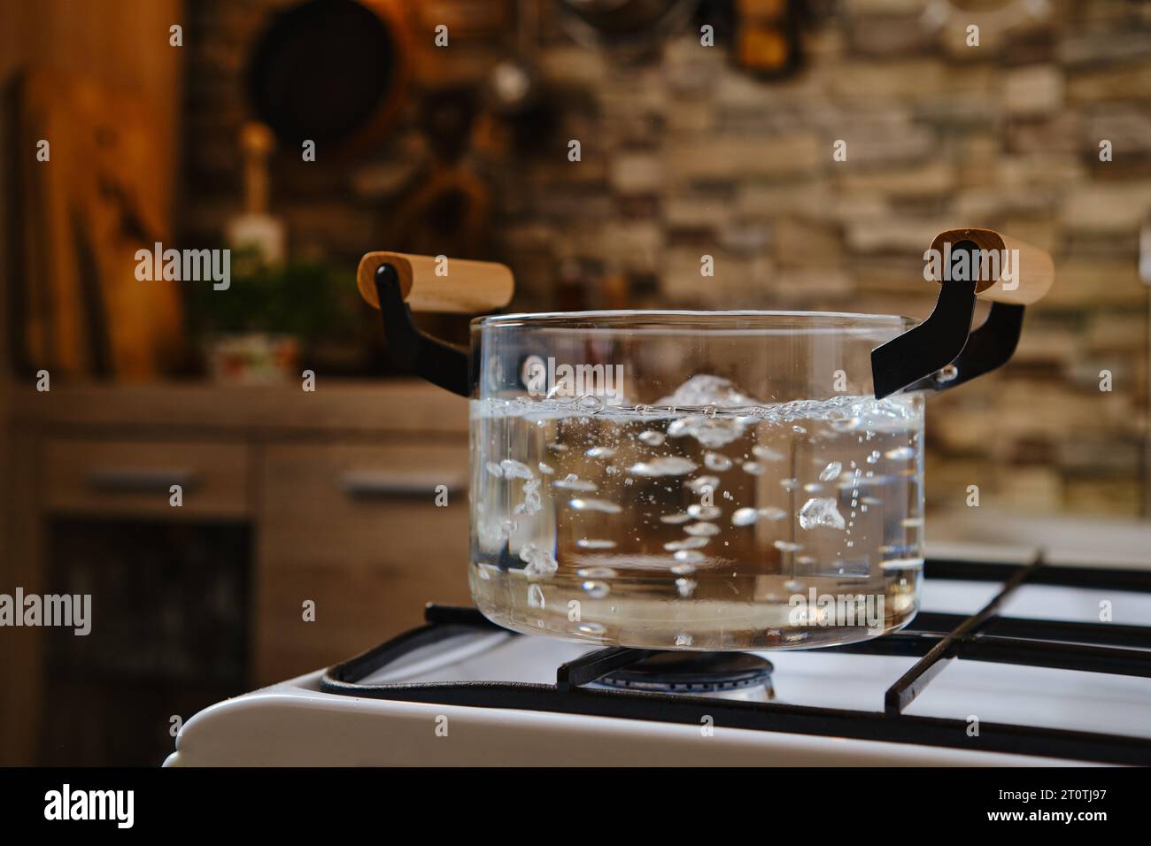 Water boiling in transparent glass pot on stove Stock Photo Alamy