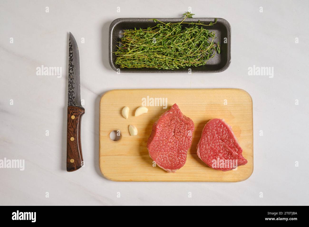 Top view of two raw beef steaks on cutting board Stock Photo