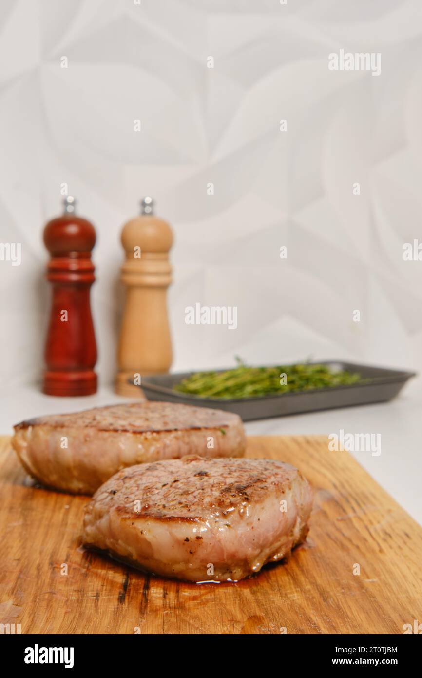Selective focus photo of homemade beef steak on wooden cutting board Stock Photo