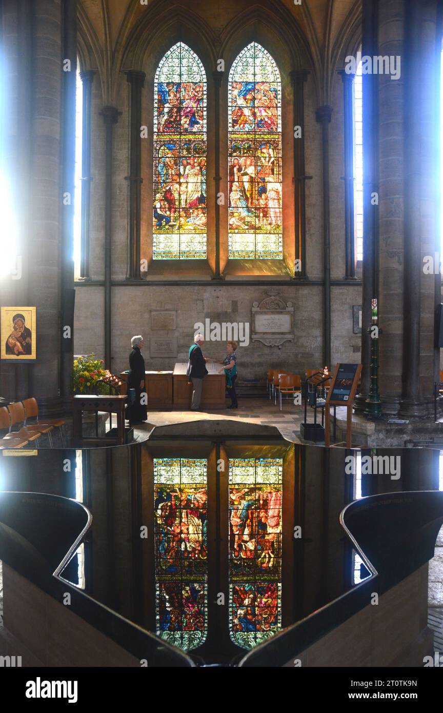 Reflection of Stained Glass Widows in the Water of the Christening Font Inside the Anglican Cathedral Church in Salisbury, Wiltshire, England, UK. Stock Photo