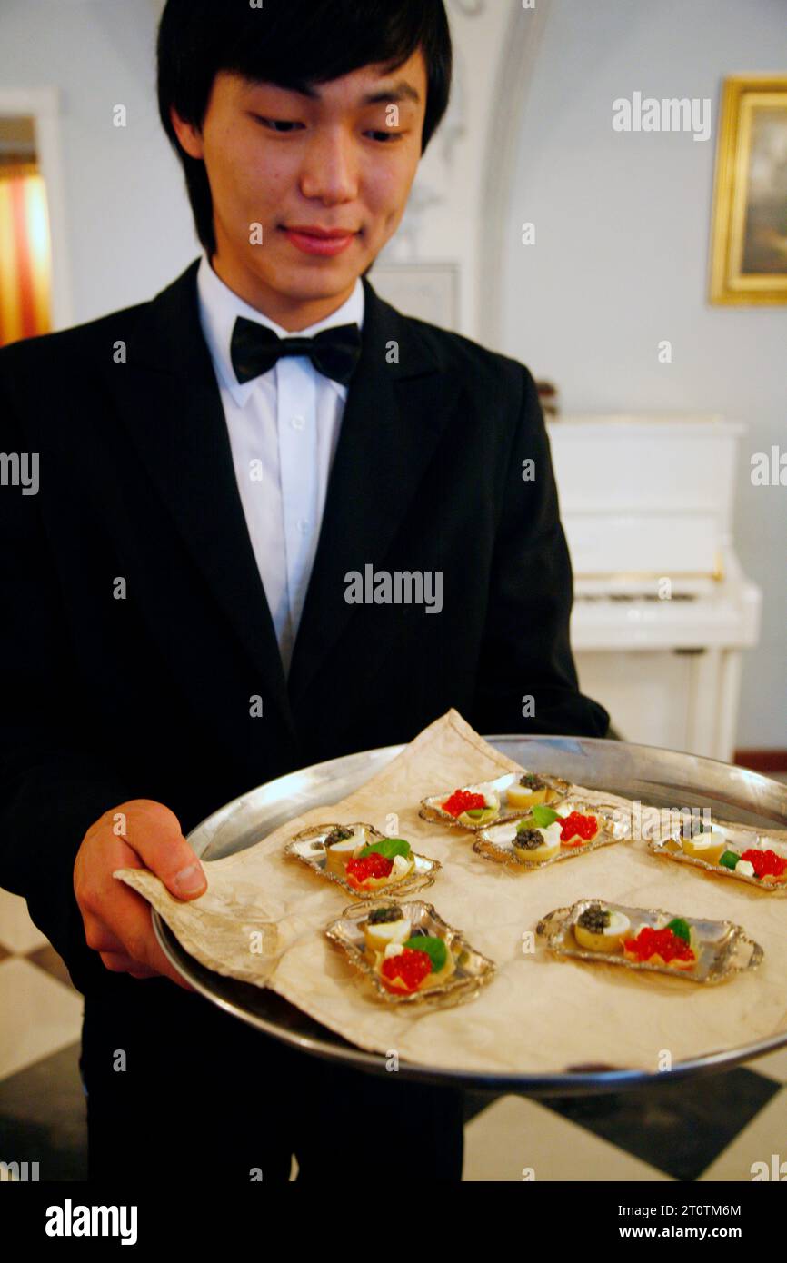 Waiter holdinga plate of red caviar at the Russian Empire considered as the most exquisite restaurant in Russia, St. Petersburg, Russia. Stock Photo