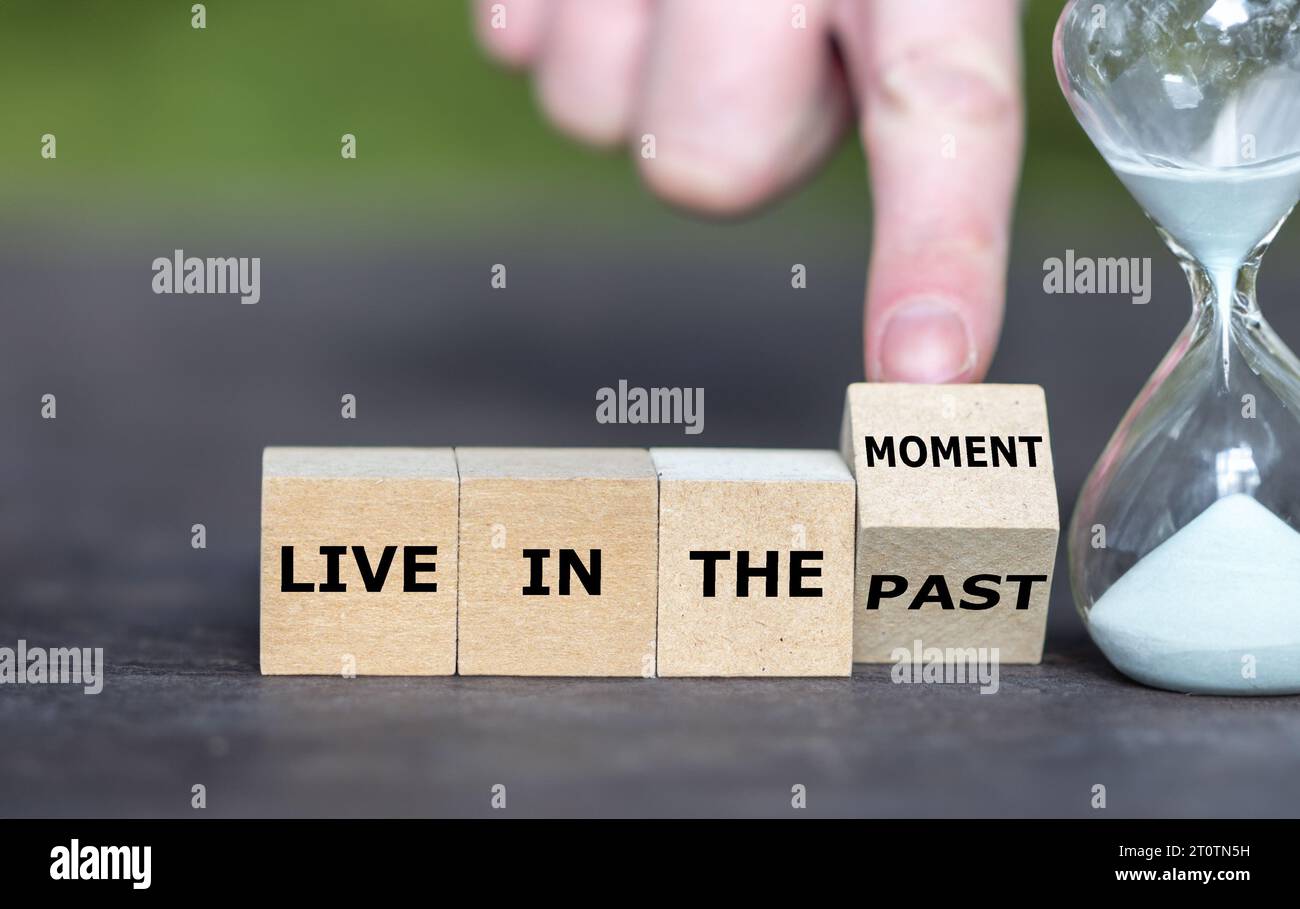 Wooden cubes form the expression 'live in the moment'. Stock Photo