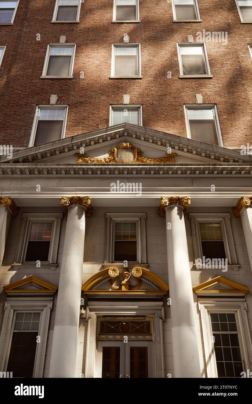 entrance of brick building with columns and portico, vintage