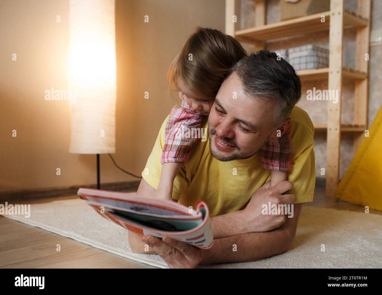 Dad and little daughter reading a book Stock Photo