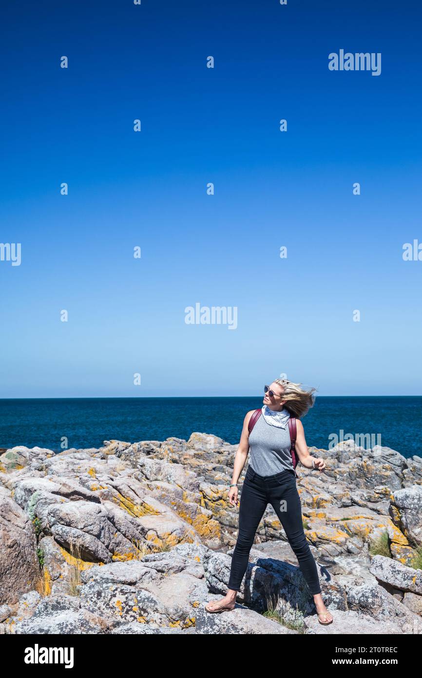 Woman With Long Hair Blowing In The Wind Next To Ocean Stock Photo - Alamy