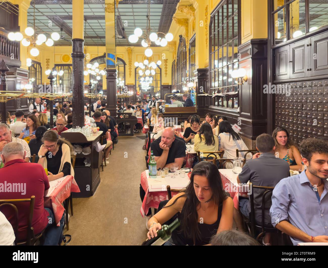 Diners enjoy traditional French cuisine at the historic Art Nouveau style Bouillon Chartier restaurant, in the Grands Boulevards district of Paris, Fr Stock Photo